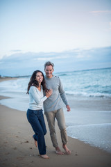 Poster -  middle-aged couple walking on the beach