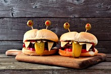 Halloween Monster Hamburgers On A Paddle Board Against An Old Wood Background