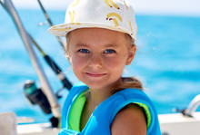 Lovely Smiling Little Girl On The Boat Fishing