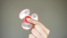 Women's Hand Holding Rotating Spinner In Her Hand. Spiner Close-up.