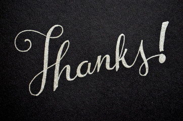 THANKS hand lettered in silver pen on black card