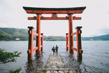 Back View Of A Young Hipster Couple At Itsukushima Shrine, Japan