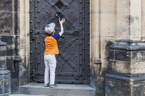 1397495 Boy Knocking In Door Knocker On Old Medieval Castle Buy