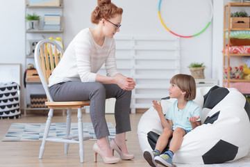 Wall Mural - Young boy talking with counselor