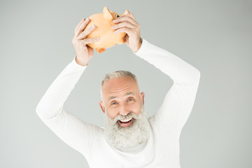 Wall Mural - senior man with piggy bank