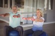 © WavebreakMediaMicro - Senior couple sitting on fitness balls with dumbbells