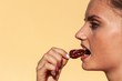 © martinfredy - Young beautiful girl eats chilli. Portrait of a beautiful woman with a hot pepper. Healthy diet. Spicy food.