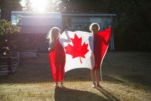 Two Girls And A Canadian Flag.