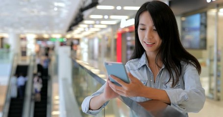 Sticker - Woman using smart phone inside shopping mall