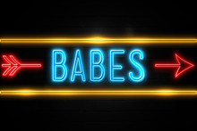 Babes  - Fluorescent Neon Sign On Brickwall Front View