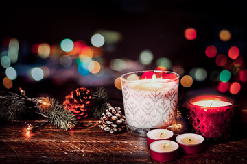 Wall Mural - Christmas background - Christmas candle and rustic decoration on wood table with christmas lights background in night party. vintage color style.