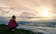 © sompong_tom - Women sitting morning sun in mist and fog scenery mountain background