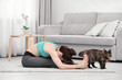 © Africa Studio - Young beautiful woman with cat practicing yoga pose at home