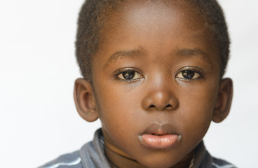 Wall Mural - Portrait of little angry and sad African ethnicity boy