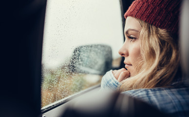 Wall Mural - Thoughtful woman travelling by a car