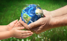 The Man Gives Planet Earth To Baby. Ecology Concept. Elements Of This Image Furnished By NASA