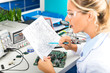 © Scanrail - Female electronic engineer checking electronic circuit in laboratory
