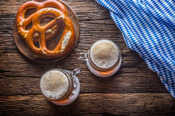 Wall Mural - Beer and Oktoberfest. Draft beer pretzel and blue checkered tablecloth as traditional products for bavarian festival oktoberfest