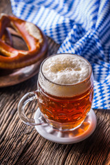 Wall Mural - Beer and Oktoberfest. Draft beer pretzel and blue checkered tablecloth as traditional products for bavarian festival oktoberfest