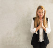 © kittipong - Happy young caucasian woman standing with Thai culture Sawasdee,Welcome expression Sawasdee on gray walls background ,with copyspace