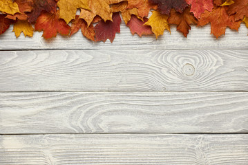 Wall Mural - Wooden background with autumn leaves