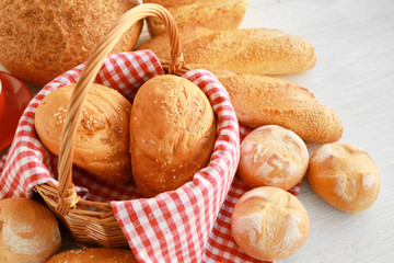 Sticker - Wicker basket and delicious bread on wooden table