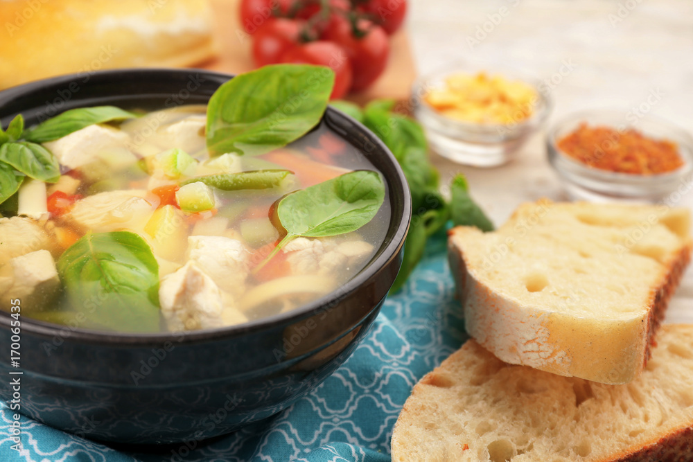 Bowl with delicious turkey soup on table, closeup