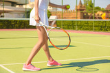 Fototapeta Sport - Young woman playing tennis on court