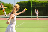 Young woman playing tennis on court