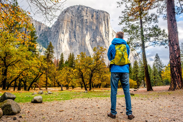 Wall Mural - tourist with backpack hiking in yosemite national park valley at cloudy autumn morning