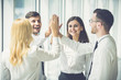 © realstock1 - The four business people greeting with a high five