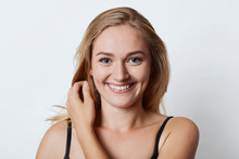 Headshot Of Attractive Female With Charming Smile, Having Blue Eyes And Dimples On Cheeks Rejoicing Summer Vacations, Going To Spend Them Abroad With Her Boyfriend. Beauty And Emotions Concept