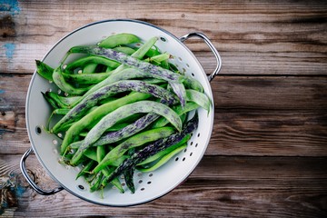 fresh raw french green beans on a wooden background