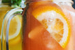 Background of fresh cold strawberry cocktail in jar. Close up picture of glass wall of fruit drinks with drops of water, sliced orange shape and mint, refreshment and coolness concept
