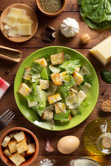 Wall Mural - caesar salad in plate at wood