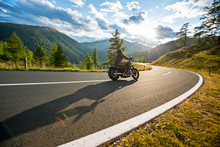 Motorcycle Driver Riding In Alpine Highway, Nockalmstrasse, Austria, Europe.