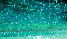 Green Sparkling Lights Festive Background With Texture. Abstract Christmas Twinkled Bright Bokeh Defocused And Falling Stars. Winter Card Or Invitation.