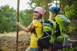 © dreamsnavigator - Girls with backpack in hill forest. Adventure, travel, tourism concept