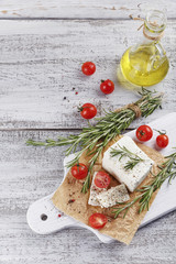 Wall Mural - Fresh feta cheese with rosemary on white wooden serving board