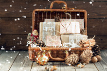 Christmas And New Year Composition With Wicker Basket With Christmas Gifts And Christmas Decorations On Wooden Background