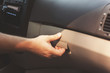 Male hand opens the glove compartment in the car, retro toning