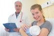 © auremar - doctor and smiling woman holding baby