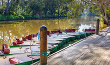 Studley Park Boathouse, Thames Replica Row Baots Are Tied To The Jetty On The Yarra River In Kew, Melbourne, Australia