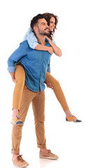 Wall Mural - side view  of  smiling man carrying his girlfriend on back