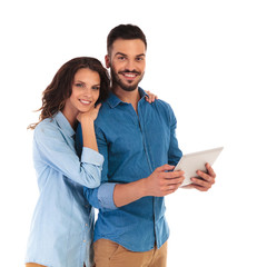 Wall Mural - smiling happy casual couple with a tablet pad computer