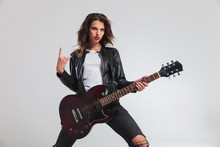 Cool Woman Guitarist Making A Rock And Roll Hand Sign