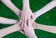 © weedezign - Close up asian business people hands together over green grass out of office,Teamwork concept