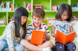 © weedezign - Children sitting on floor and reading tale book  in preschool library,Kindergarten school education concept.