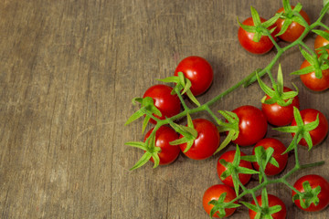 Fresh cherry tomato on rustic wood table. Top view cherry tomato for background or wallpaper. Prepare fresh cherry tomato for home cooking look so delicious. Top view with copy space in vintage tone.