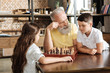 © zinkevych - Grandfather giving his grandson a tip in chess game